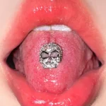 body-jeweller-skull-tongue-stud-1 Silver sparkling gothic skull tongue stud piercing model shot - Bubbleoo