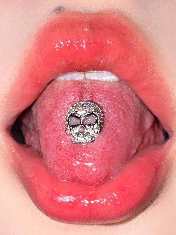 body-jeweller-skull-tongue-stud-1 Silver sparkling gothic skull tongue stud piercing model shot - Bubbleoo